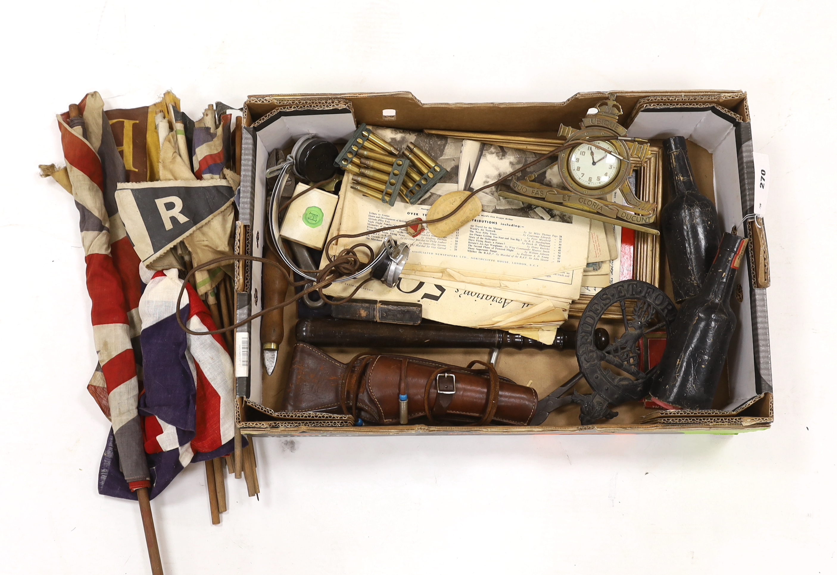 A collection of Militaria and other items, including a Royal Artillery brass cased timepiece, headphones, crepe paper bunting contained in a card Worthington’s IPA beer bottle, etc.